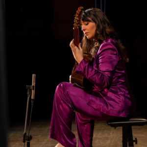 Andrea González Caballero playing guitar