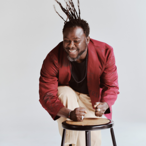 Okaidja Afroso drumming on a stool