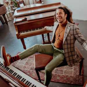 Emmet Cohen playing three pianos with his limbs