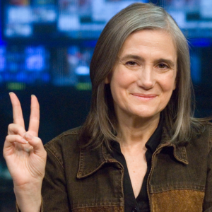 Amy Goodman holding up a peace sign